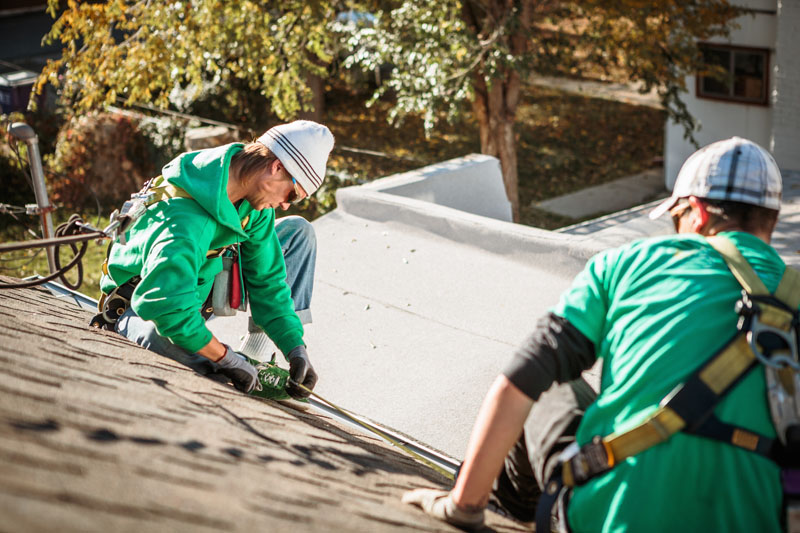 Solar panel installation crew members on roof of house Solar Leads with Adsurdly